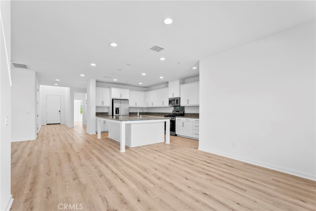 18121 Outlook Way Saugus, CA 91350 - Photo 7 of 59 a large kitchen with kitchen island a sink stainless steel appliances and white cabinets