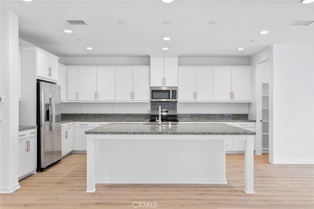 18121 Outlook Way Saugus, CA 91350 - Photo 9 of 59 a kitchen with granite countertop a sink and cabinets
