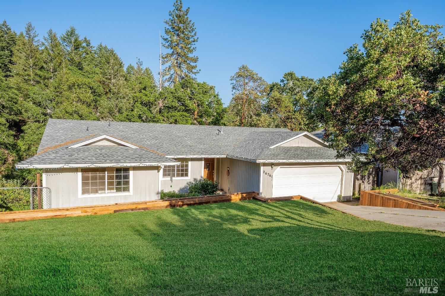a front view of a house with a garden
