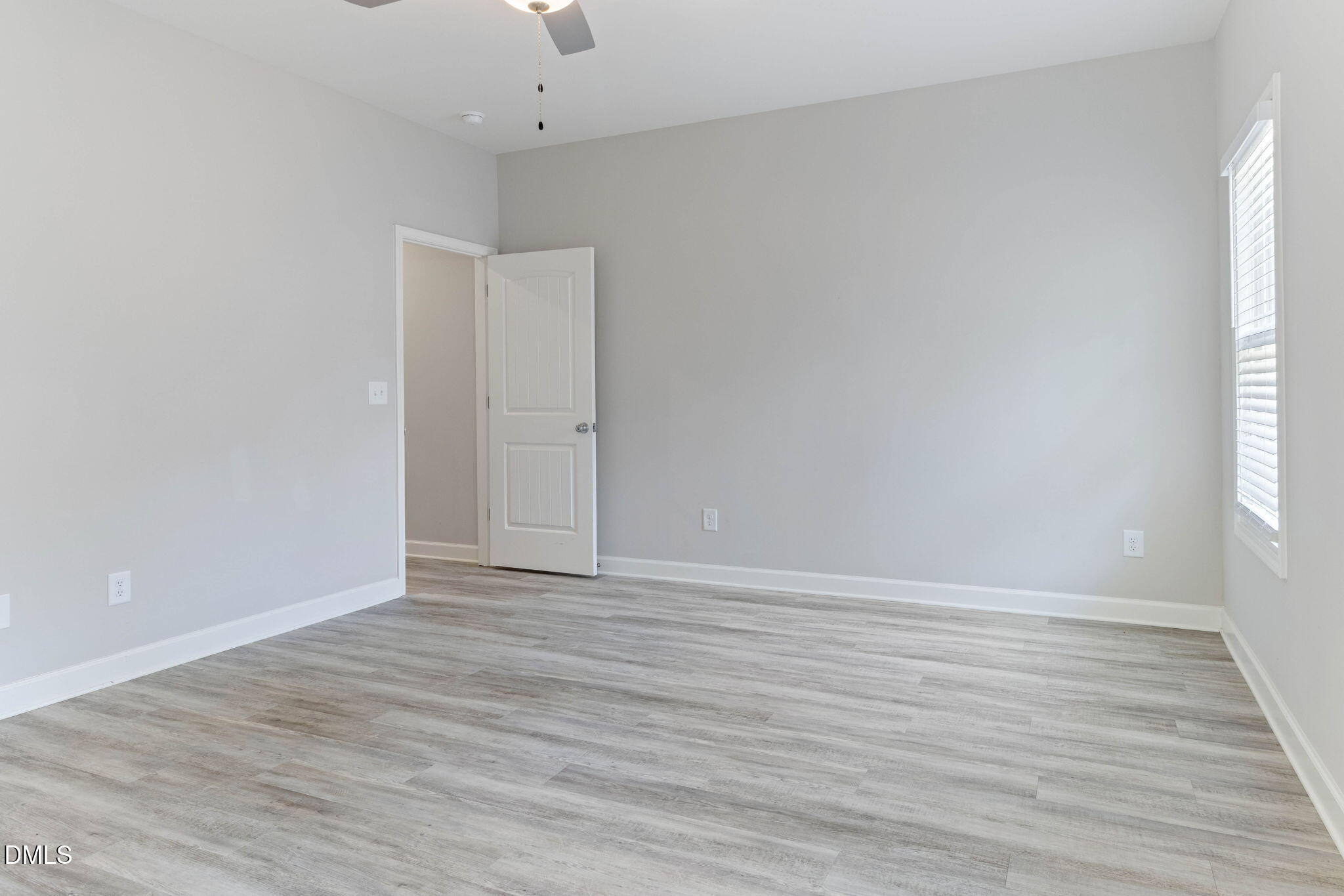 111 Sugarberry Place Spring Lake, NC 28390 - Photo 13 of 29 a view of an empty room with wooden floor and a window