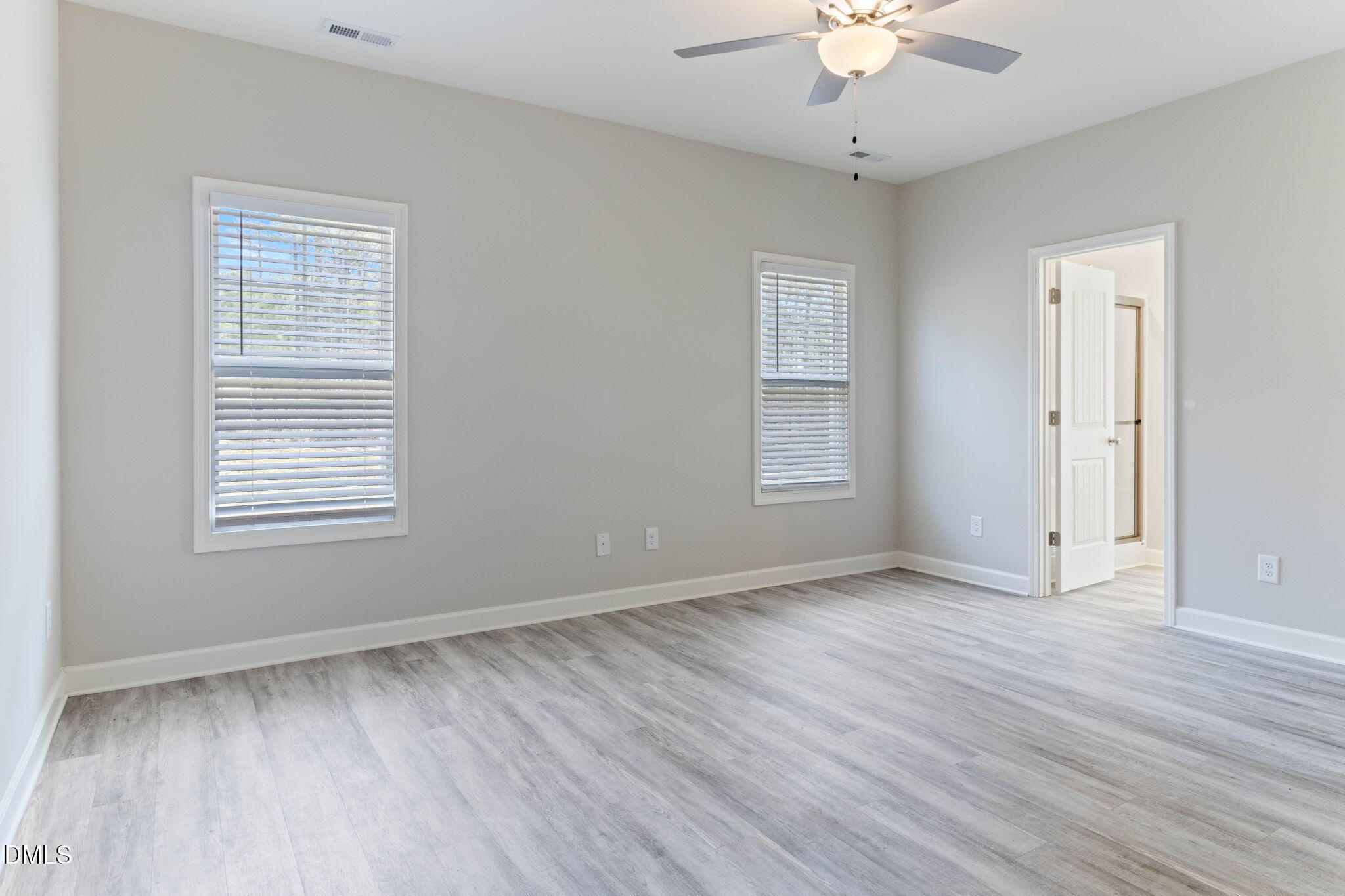 111 Sugarberry Place Spring Lake, NC 28390 - Photo 14 of 29 a view of an empty room with wooden floor and a window