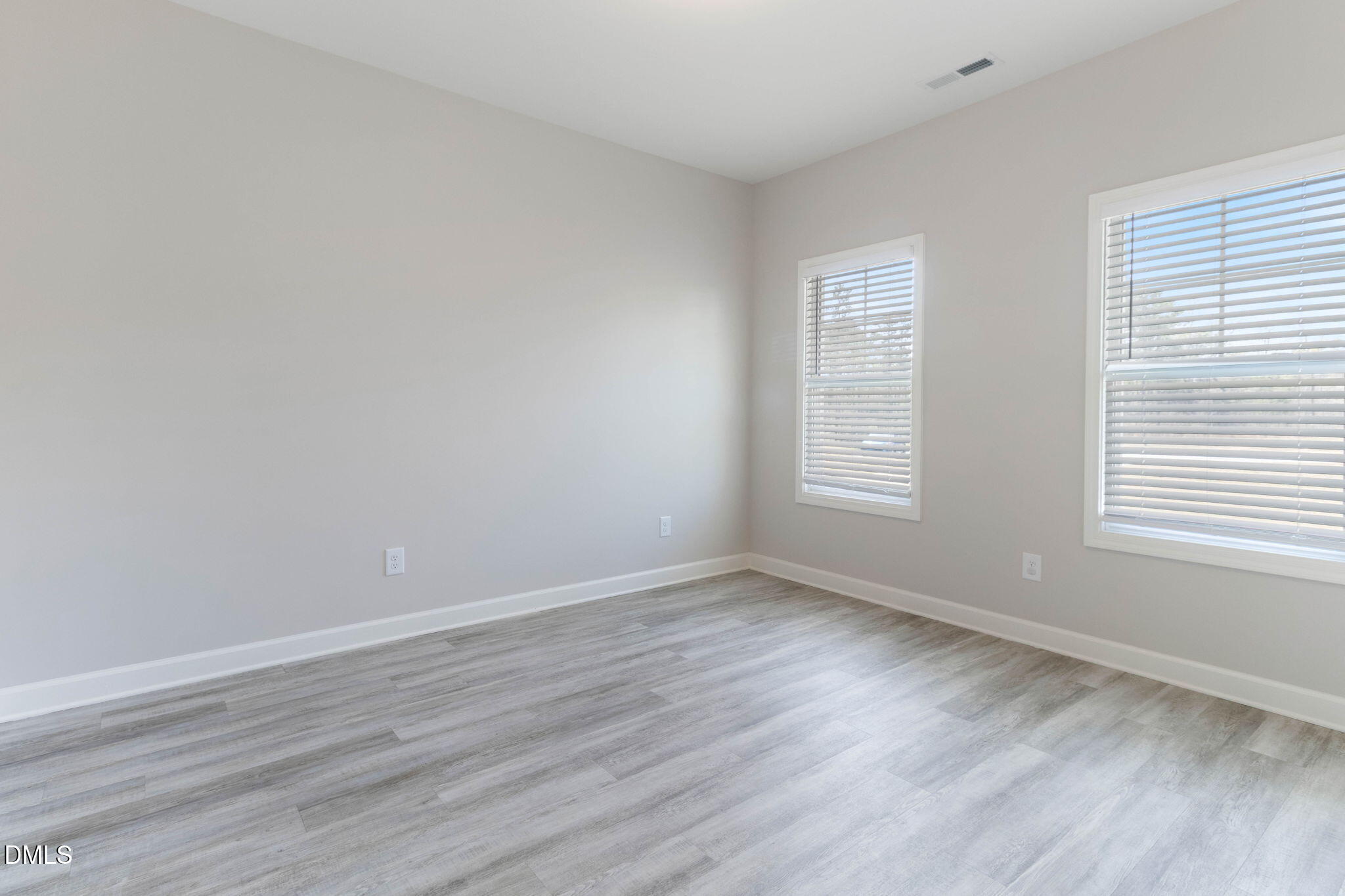 111 Sugarberry Place Spring Lake, NC 28390 - Photo 19 of 29 a view of an empty room with wooden floor and a window