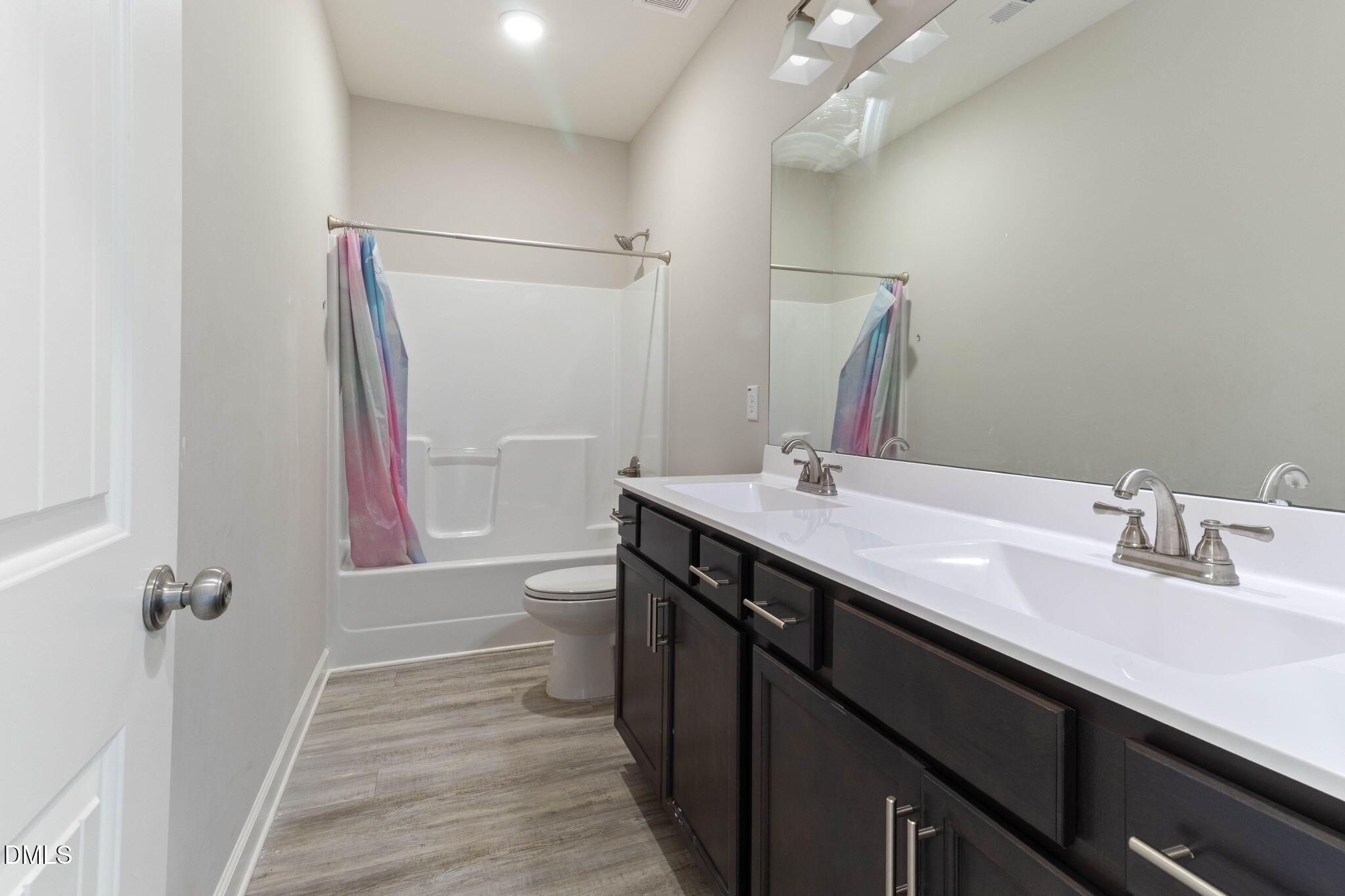 111 Sugarberry Place Spring Lake, NC 28390 - Photo 23 of 29 a bathroom with a double vanity sink a toilet and a mirror