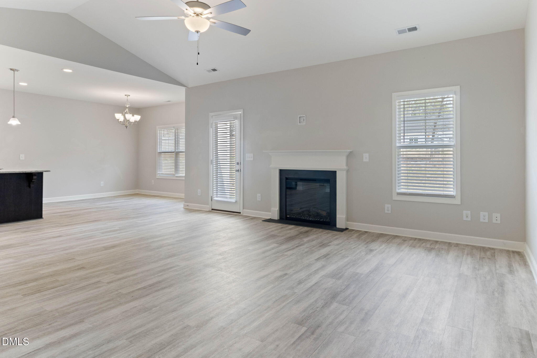 111 Sugarberry Place Spring Lake, NC 28390 - Photo 5 of 29 an empty room with wooden floor fireplace and windows