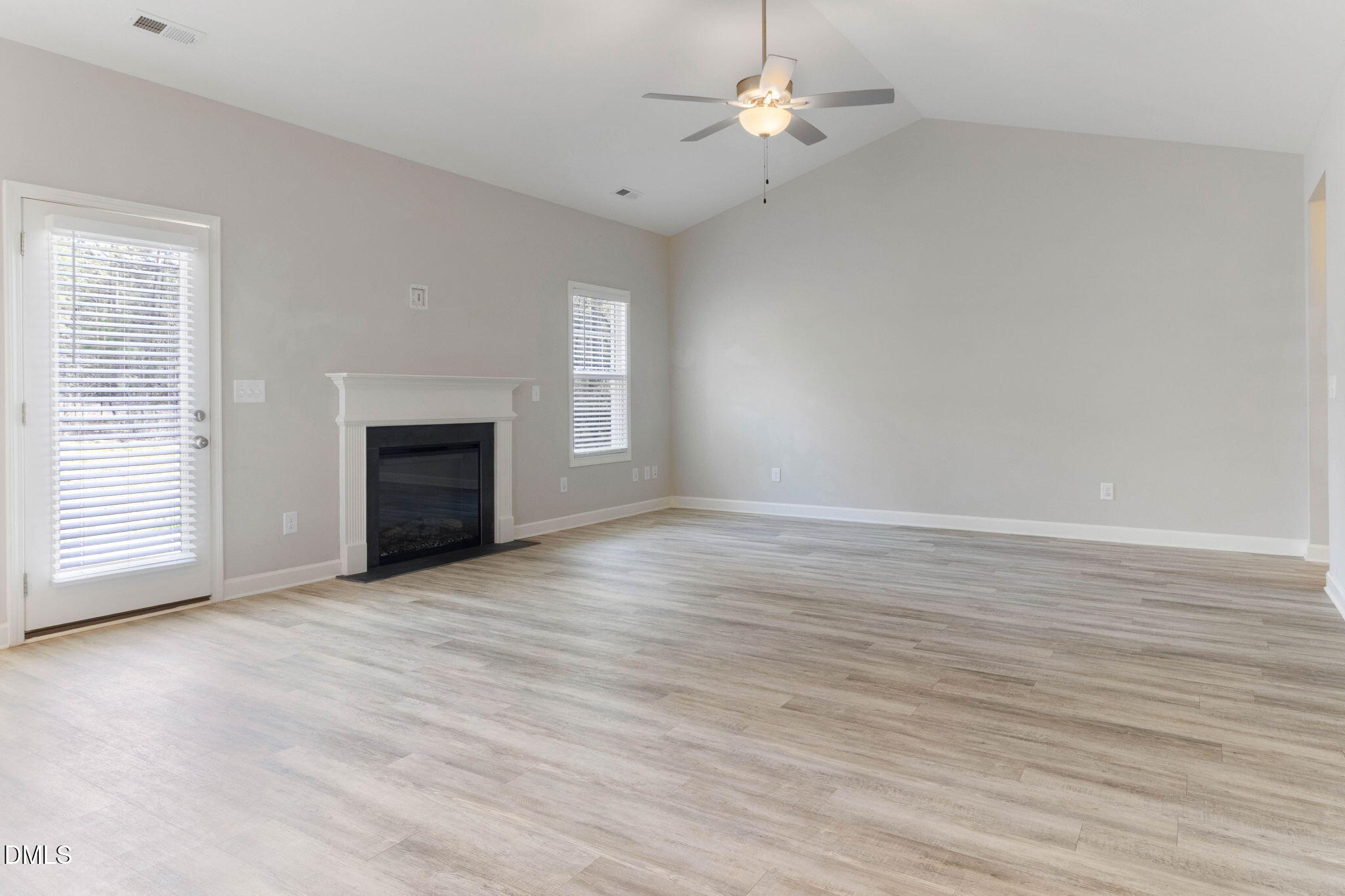 111 Sugarberry Place Spring Lake, NC 28390 - Photo 6 of 29 an empty room with wooden floor fan and windows