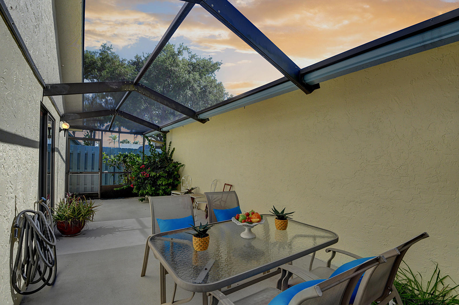 9150 Southwest 20th Street, Unit A Boca Raton, FL 33428 - Photo 31 of 47 Screened in Patio Twilight Fun Picture