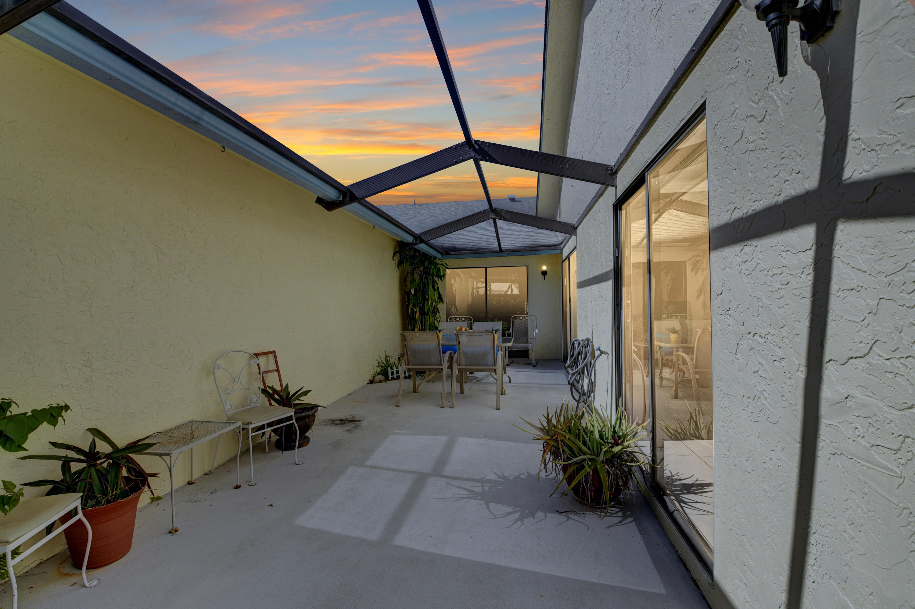 9150 Southwest 20th Street, Unit A Boca Raton, FL 33428 - Photo 34 of 47 Screened in Patio Twilight Fun Picture