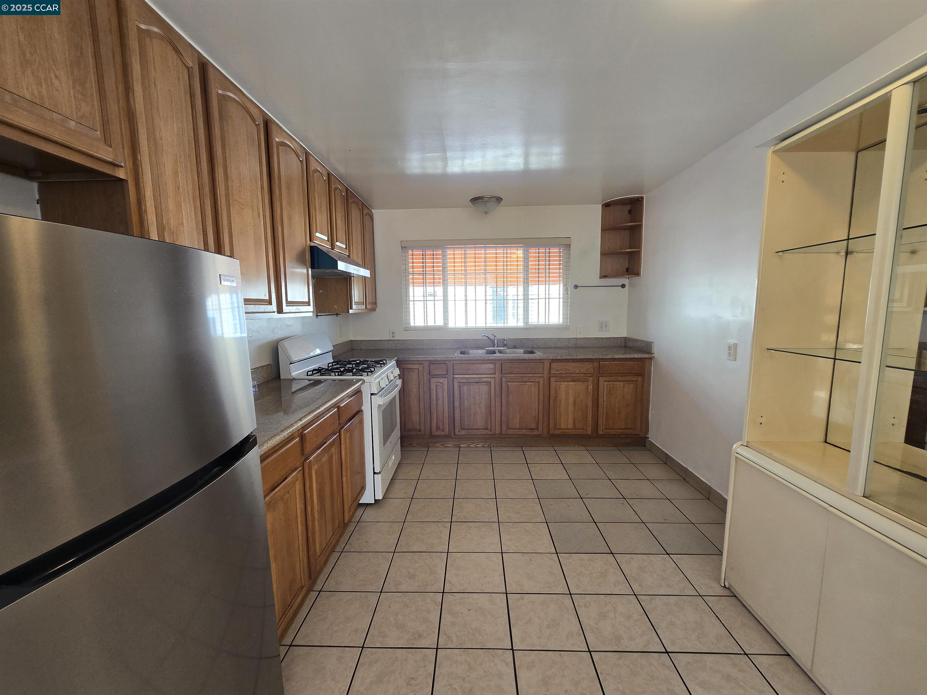 2849 Rheem Avenue Richmond, CA 94804 - Photo 3 of 10 a kitchen with stainless steel appliances granite countertop a refrigerator a sink a stove a microwave and island