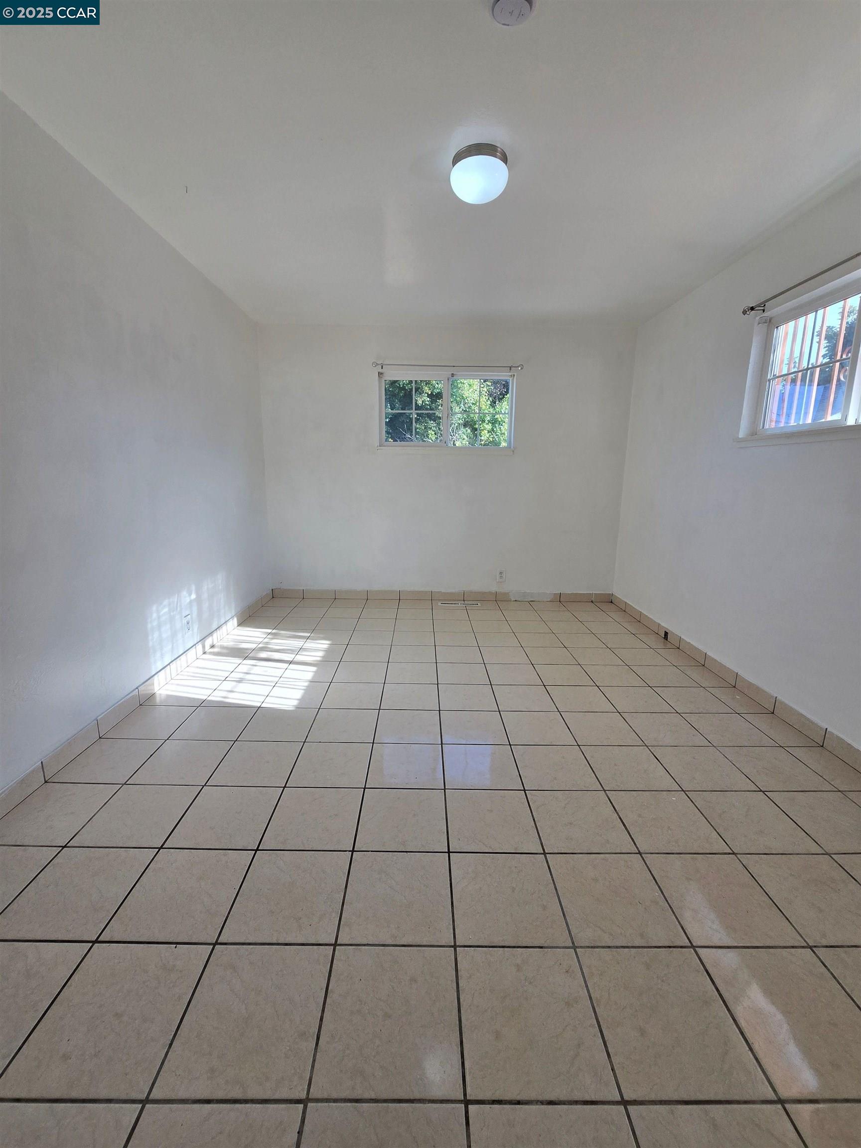 2849 Rheem Avenue Richmond, CA 94804 - Photo 6 of 10 an empty room with white walls and outdoor space
