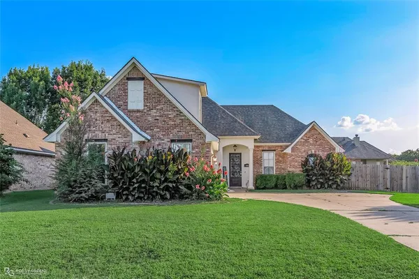 a front view of a house with garden