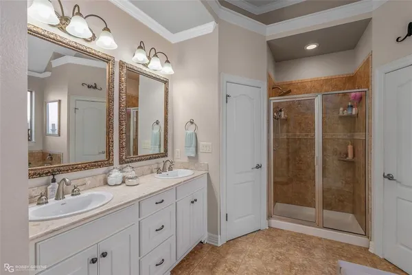 a bathroom with a shower sink double and mirror