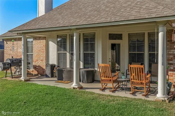 a view of a house with backyard sitting area and garden