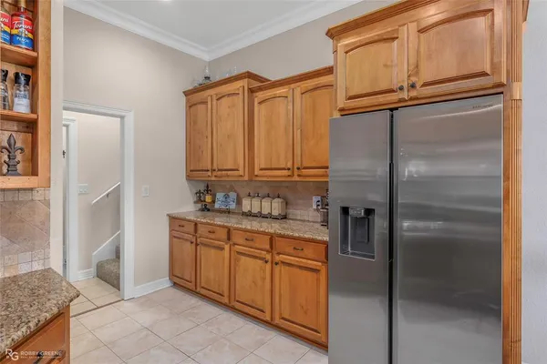 a kitchen with stainless steel appliances granite countertop a refrigerator and a sink