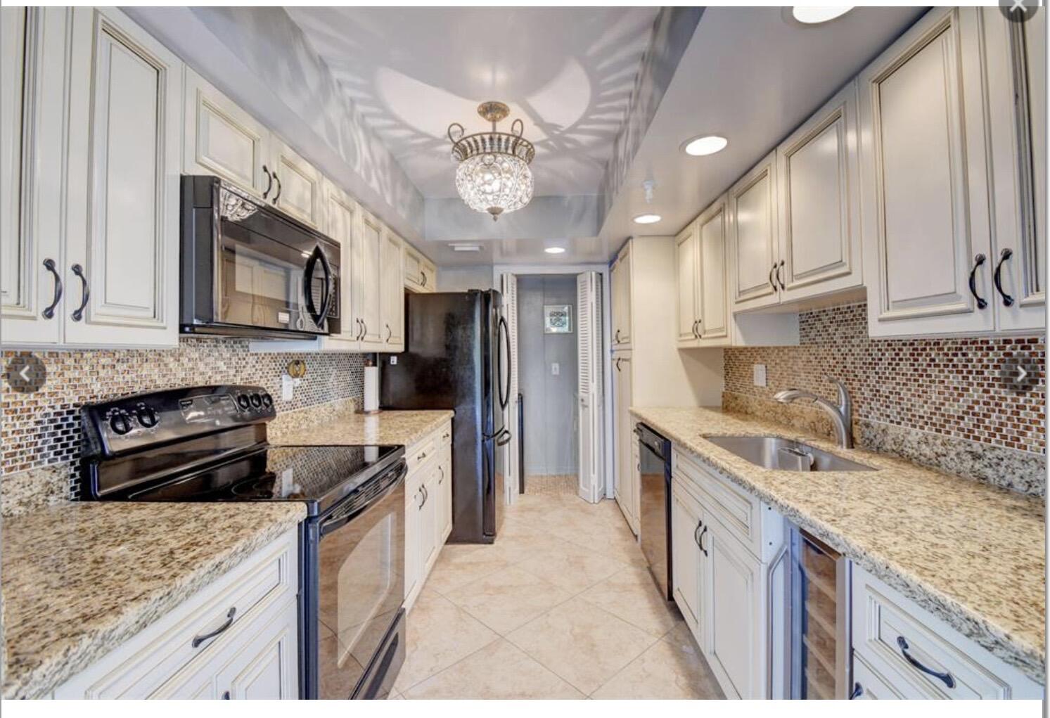 859 Jeffery Street, Unit 3030 Boca Raton, FL 33487 - Photo 5 of 24 a kitchen with stainless steel appliances granite countertop a sink stove microwave and cabinets