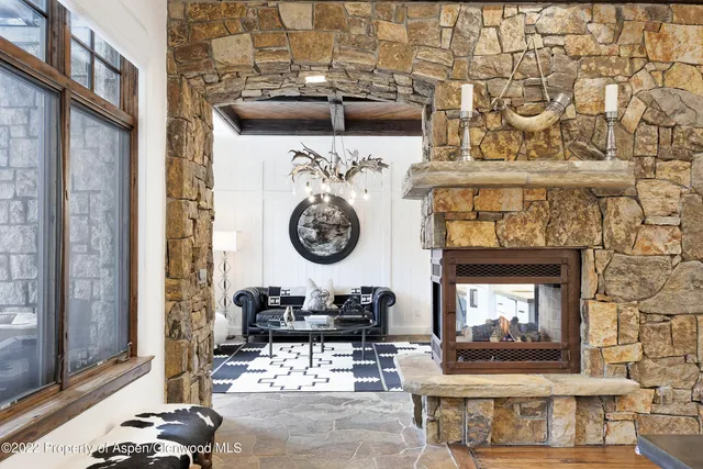 a living room with fireplace and a wooden floor