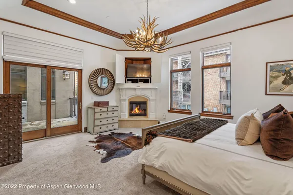 a bedroom with bed and a large window