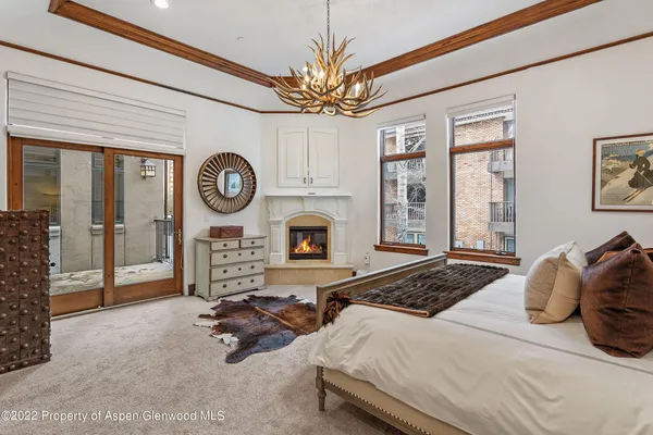 a bedroom with a bed a mirror and a large window