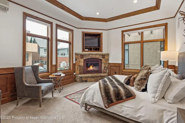 a bedroom with furniture and a fireplace