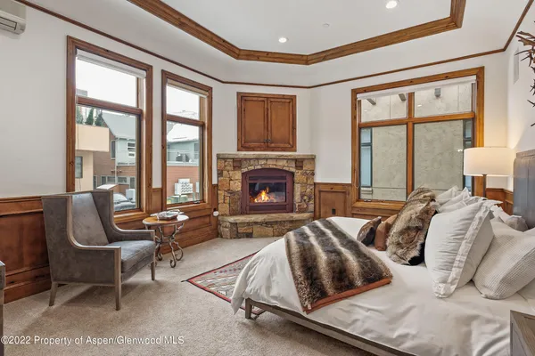 a bedroom with furniture and a fireplace