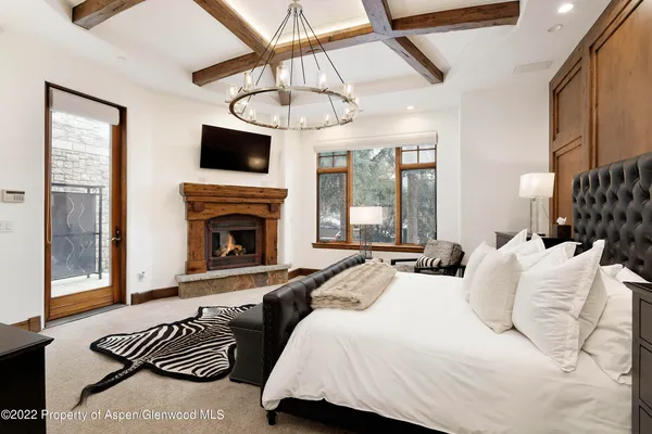 a bedroom with furniture and a fireplace