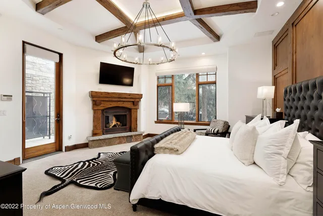 a bedroom with furniture and a fireplace