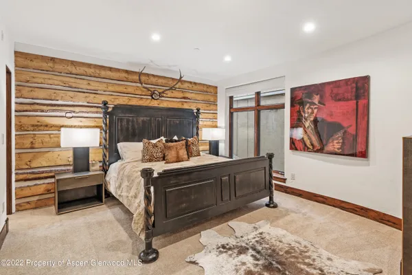 a bed sitting in a room next to a window