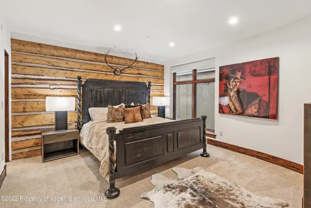 a bed sitting in a room next to a window