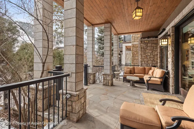 a front view of a house with chairs and table
