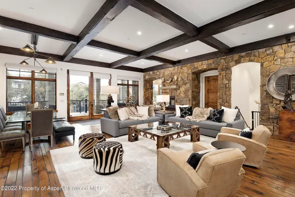 a living room with patio furniture and a large window