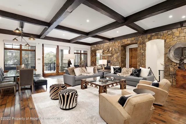 a living room with patio furniture and a large window