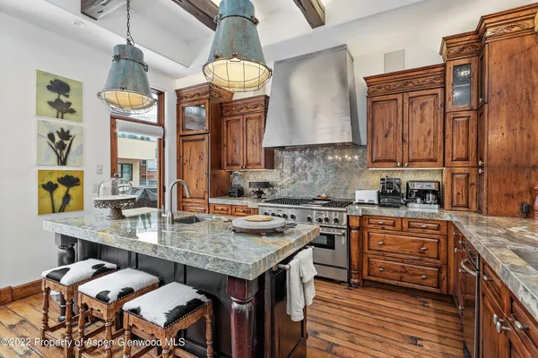 a kitchen with a table chairs stove and cabinets