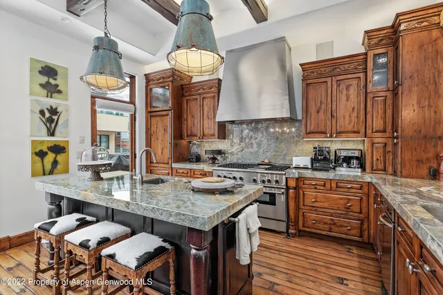 a kitchen with a table chairs stove and cabinets