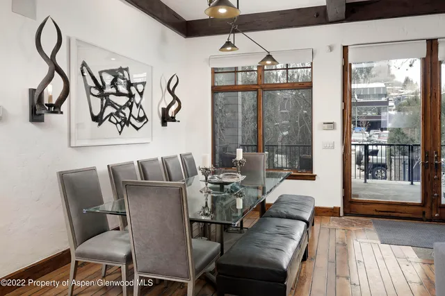 a view of a dining room with furniture wooden floor and a floor to ceiling window