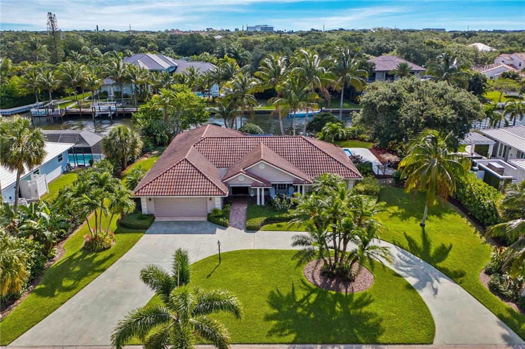 1626 Indian Bay Drive Vero Beach, FL 32963 - Photo 1 of 35 an aerial view of a house with garden space and a lake view
