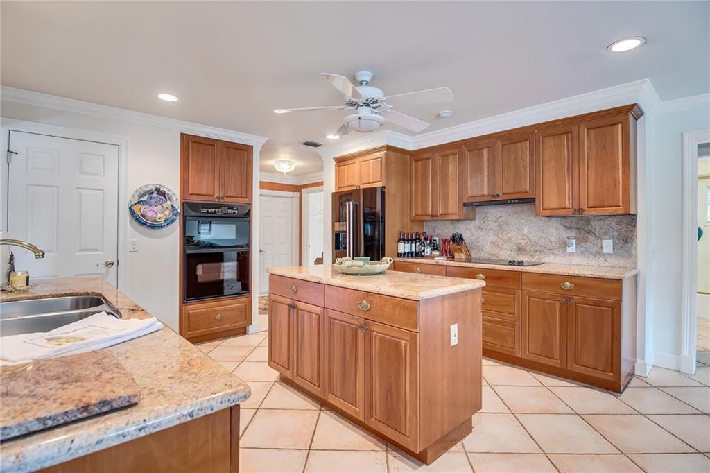 1626 Indian Bay Drive Vero Beach, FL 32963 - Photo 11 of 35 a kitchen with stainless steel appliances granite countertop a stove sink and cabinets