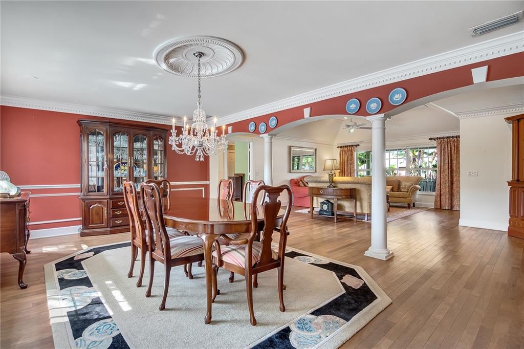 1626 Indian Bay Drive Vero Beach, FL 32963 - Photo 14 of 35 a view of a dining room with furniture wooden floor and chandelier