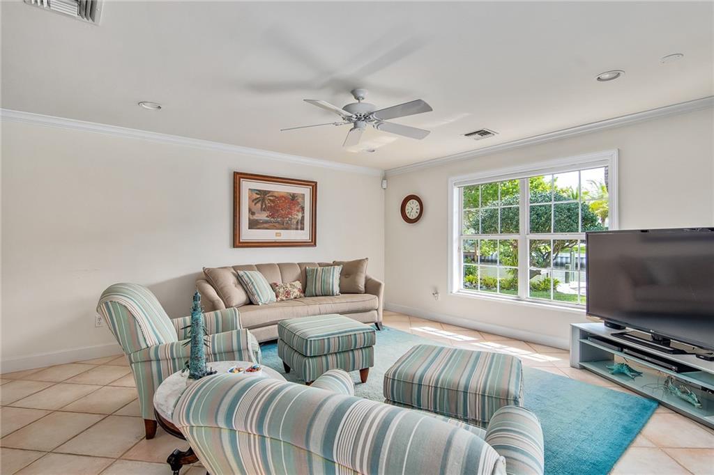 1626 Indian Bay Drive Vero Beach, FL 32963 - Photo 15 of 35 a living room with furniture a flat screen tv and a window