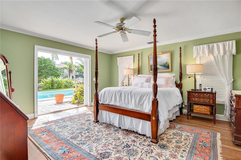 1626 Indian Bay Drive Vero Beach, FL 32963 - Photo 17 of 35 a bedroom with a bed and wooden floor