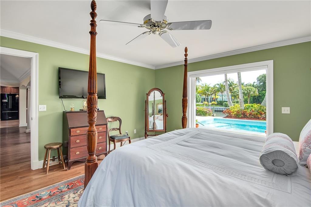 1626 Indian Bay Drive Vero Beach, FL 32963 - Photo 18 of 35 a bedroom with a bed and a flat tv screen on dresser