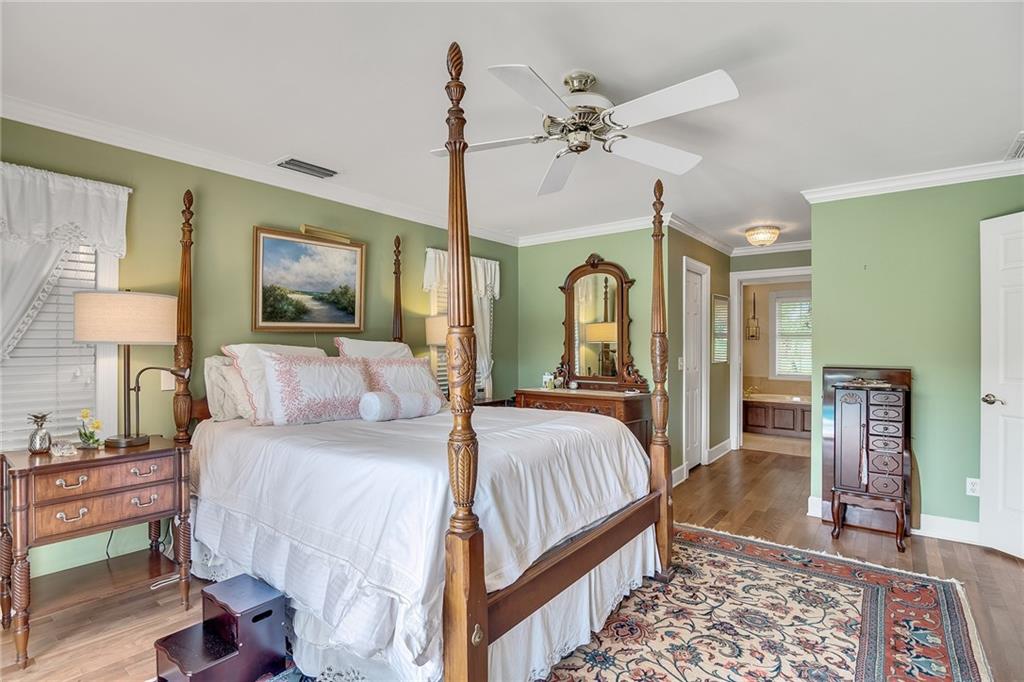 1626 Indian Bay Drive Vero Beach, FL 32963 - Photo 19 of 35 a bedroom with a bed and a mirror