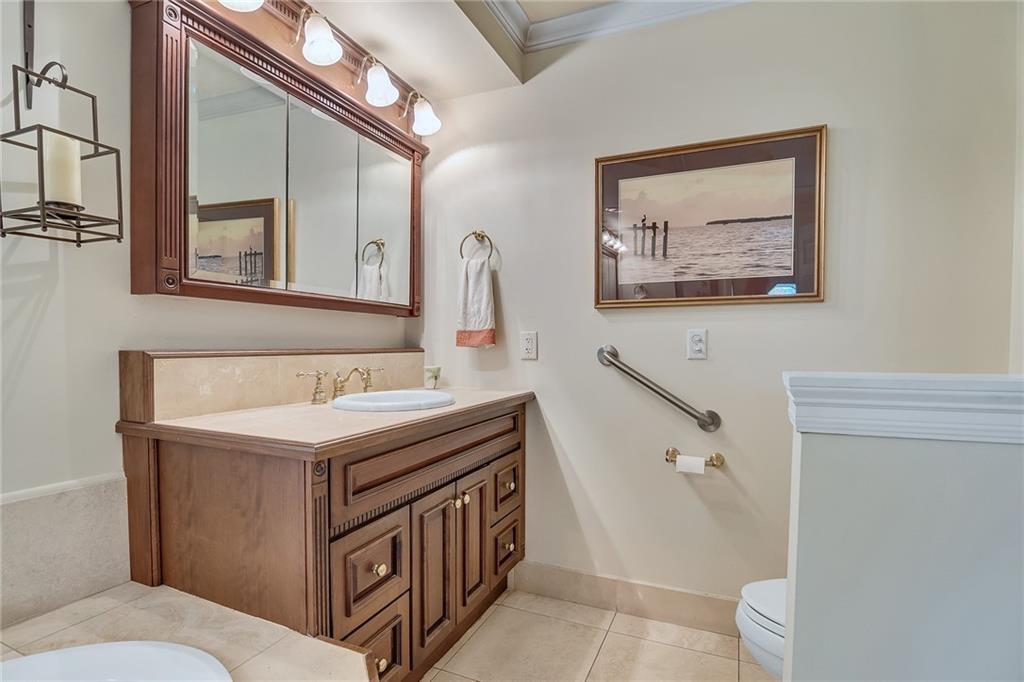 1626 Indian Bay Drive Vero Beach, FL 32963 - Photo 21 of 35 a bathroom with a sink a toilet and mirror