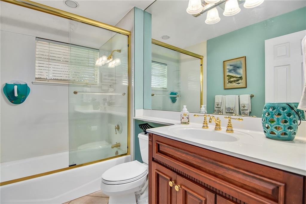 1626 Indian Bay Drive Vero Beach, FL 32963 - Photo 24 of 35 a bathroom with a sink a toilet and shower