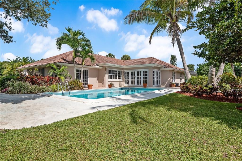 1626 Indian Bay Drive Vero Beach, FL 32963 - Photo 27 of 35 a front view of a house with a garden and plants