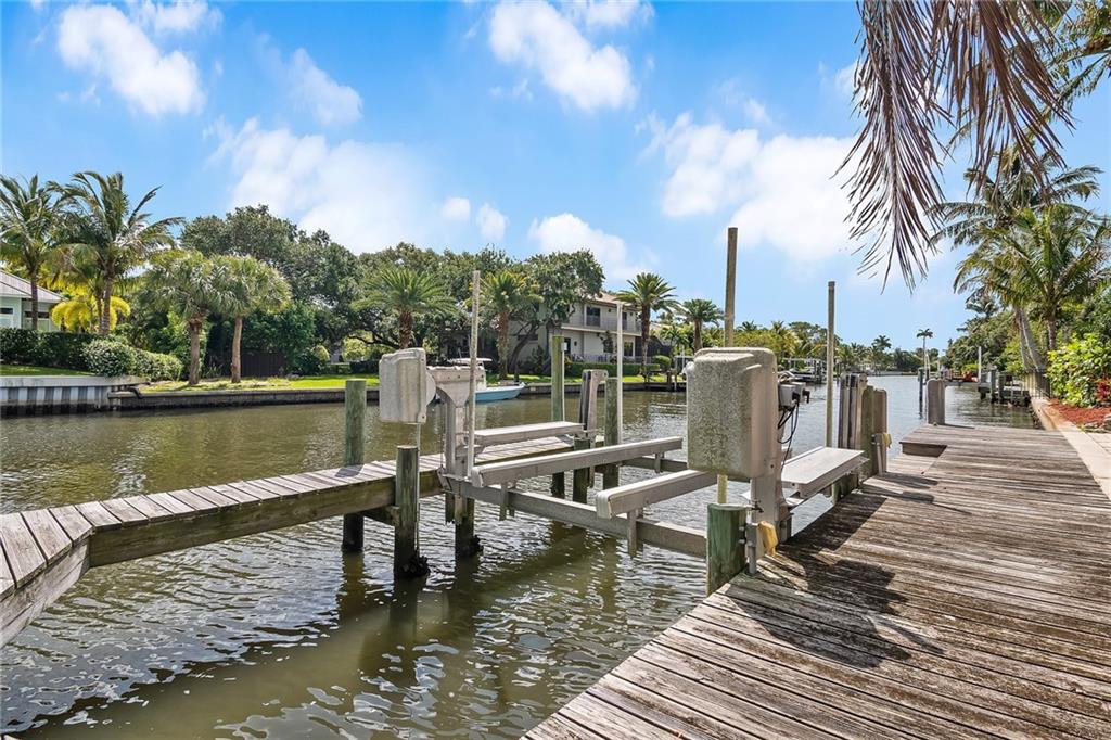 1626 Indian Bay Drive Vero Beach, FL 32963 - Photo 29 of 35 a view of a lake with boats and palm trees