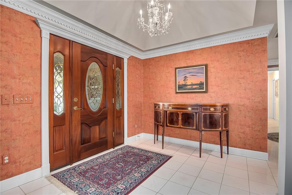 1626 Indian Bay Drive Vero Beach, FL 32963 - Photo 7 of 35 a view of a hallway with paintings on the wall