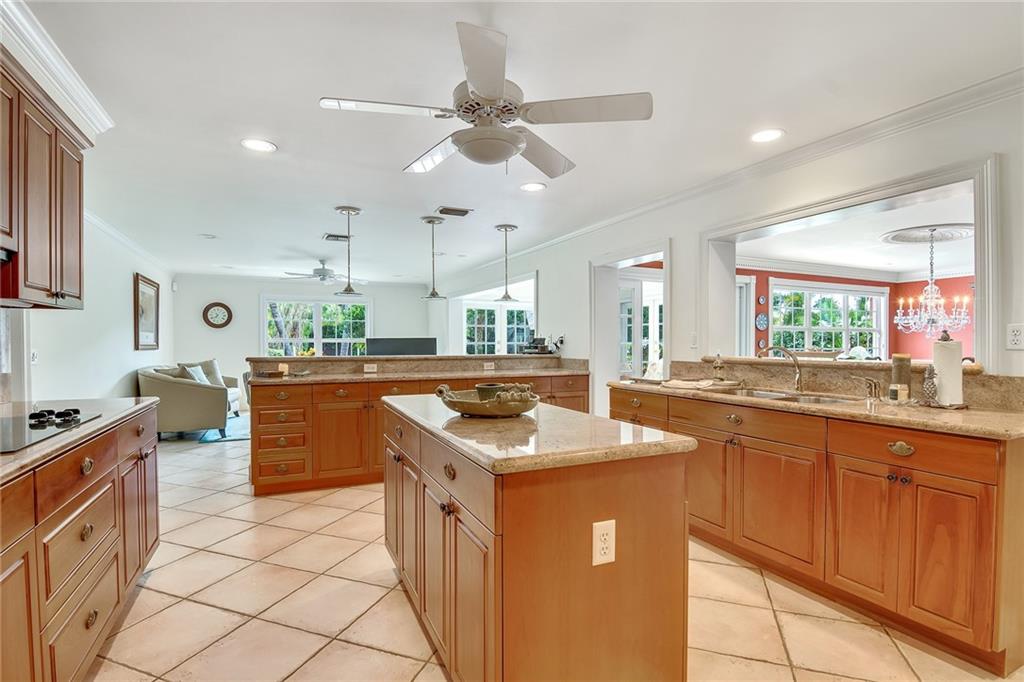 1626 Indian Bay Drive Vero Beach, FL 32963 - Photo 10 of 35 a kitchen with granite countertop a sink a counter top space and cabinets
