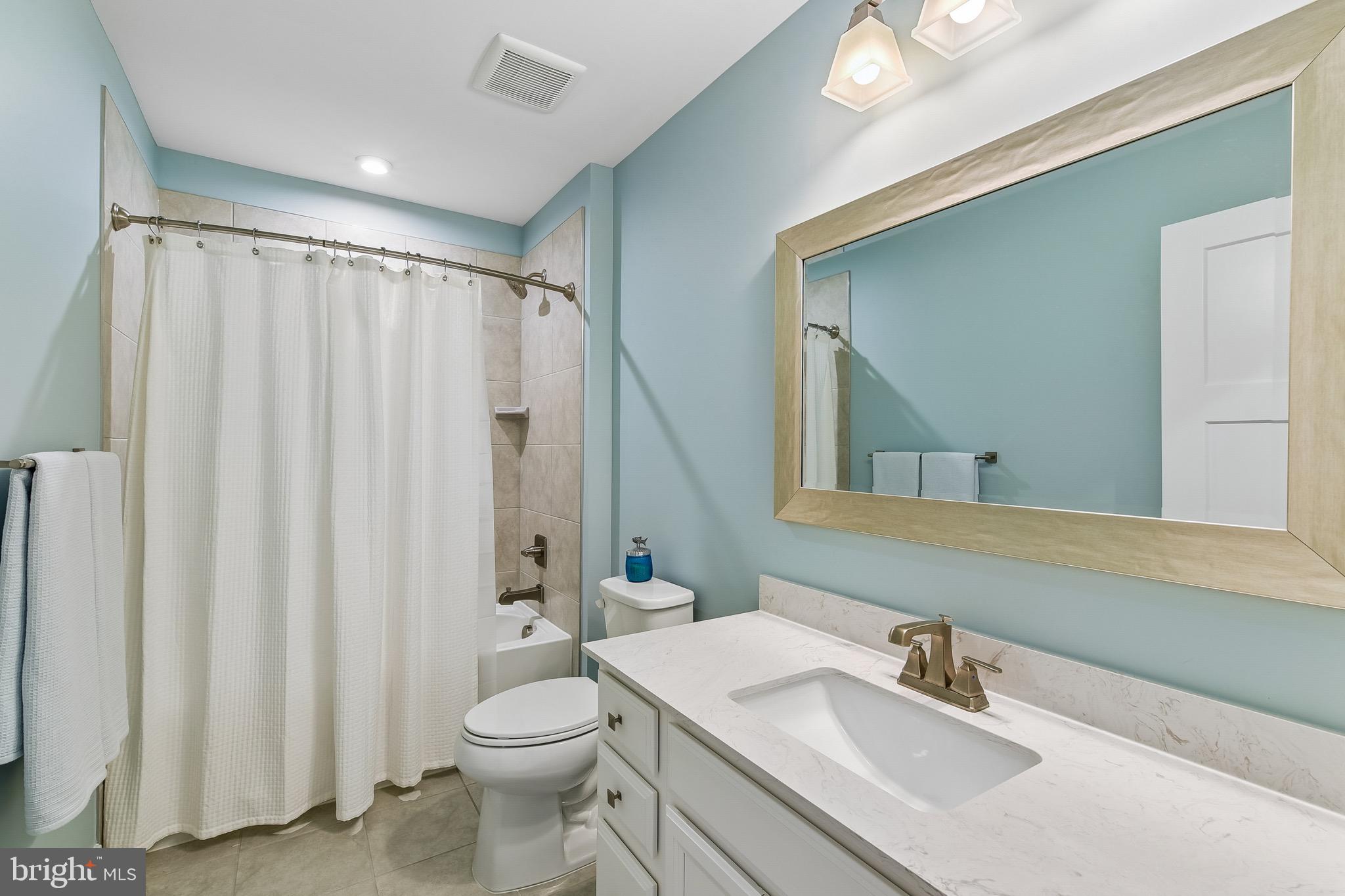 637 Iron Gate Road Bel Air, MD 21014 - Photo 22 of 35 a bathroom with a sink a toilet and shower curtain