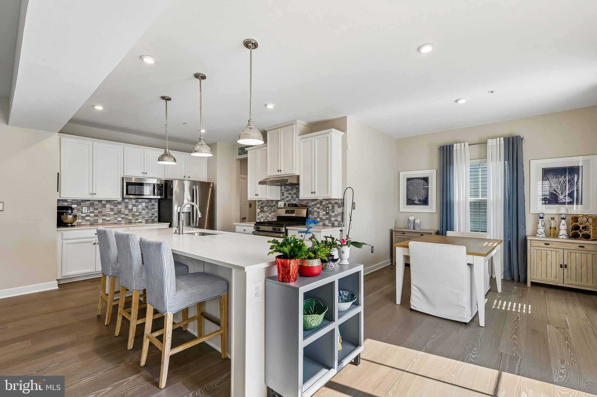 637 Iron Gate Road Bel Air, MD 21014 - Photo 9 of 35 a room with stainless steel appliances kitchen island granite countertop a dining table chairs and white cabinets