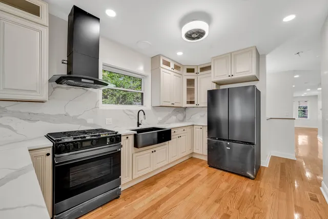 a kitchen with granite countertop a stove and a refrigerator