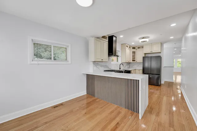 a kitchen with granite countertop a refrigerator and a sink